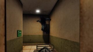 Screenshot from The Morgue Shift showing a view of a gloomy corridor. In the corner where the corridor turns left, a shadowy figure that appears to be a woman in a hospital gown, crouches up against the walls and ceiling. Screenshot from The Morgue Shift showing a view of a gloomy corridor. In the corner where the corridor turns left, a shadowy figure that appears to be a woman in a hospital gown, crouches up against the walls and ceiling.